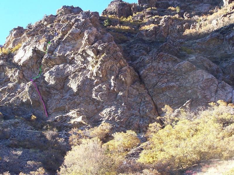 Scavenger climbs the green line over a bulge, then disappears into a corner and finishes through a chimney.  The blue circle represents a sling for a two-rope rappel.