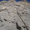 Nick leading the second pitch.  The traverse right can be seen after the third bolt.