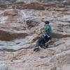 Resting at the "huge jug" just before entering the left-facing dihedral on Jump Start, 5.12a.