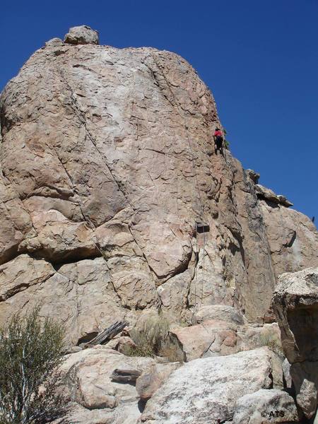 Climber on Bye Crackie, with the rope hanging to her left on the route [[105805473]]