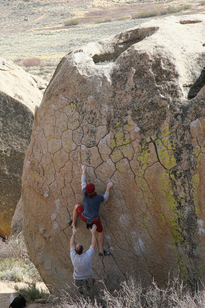 Making the crux move on Green Wall Essential, V2.