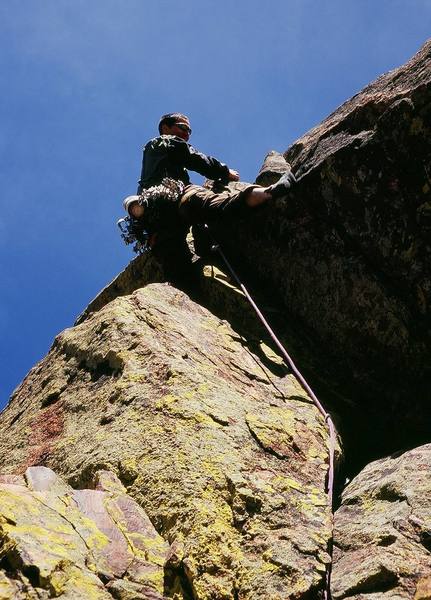 Once again right-side-up, Jason Haas surmounts the roof on P2 of Ignominity, on the West Ridge of Eldorado Canyon. Photo by Tony Bubb, 2/2007.