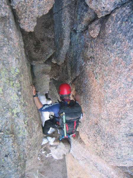 John Prater downclimbing the final chimney section.