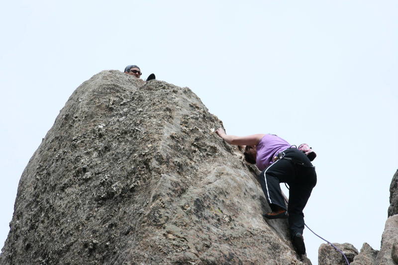 Cheryl attempts the crux on her highest Black Hills summit...