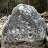 Up-turned grinding stone. This boulder was dislodged and turned to a vertical position during the flood of 1996.<br>
It's along the Merced River in El Portal.<br>
Photo by Blitzo.