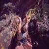 Peter Spindloe places a Camalot at the beginning of the roof on Whiplash (10c) on the West Ridge of Eldorado Canyon in Y2K. Photo by Tony Bubb.