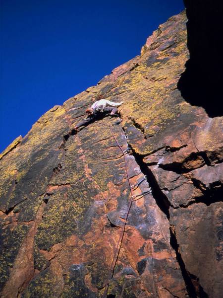 Matt Robertson a little further up the colorful first pitch of Grand Giraffe (5.9) on Redgarden Wall in Eldo. Photo by Tony Bubb, 11/2001.