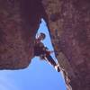 Tony Bubb looks down through 4 meters of hard earned progress through the slot of Initial Hangover. Photo by Joseffa Meir, 2002.