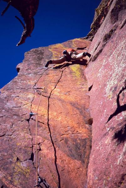 Josh Janes past the arete and back to stemming on 'Pony Express  (11c)', on Eldo's West Ridge. Photo by Tony Bubb, 2005.