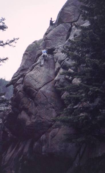 Jenny Schillinger follows 'Crack Up (5.9+)' at Broken Rock in Boulder Canyon on a gloomy afternoon. Photo by Chris Parks, 2003.