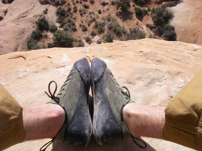 looking down on my bloody ankles and sandy climbing shoes on top of Owl Rock