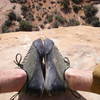 looking down on my bloody ankles and sandy climbing shoes on top of Owl Rock