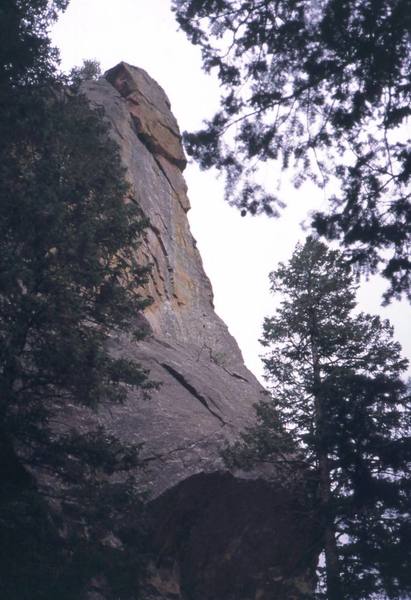 Eavesdropper climbs up on the left of this photo to reach the diagonal crack (crux) crossing the slabby face up and right. A belay is reached just below the right-hand arete in this photo. The second pitch follows this steep and runout arete.