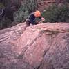 Chris Parks cleans the gear from the route on the 'NW Arete (5.8, S)' on the F.A. of that route on The Sibling. Photo by Tony Bubb.