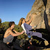 Lynn Hill (spotted by Sonny Trotter and Barry Blanchard) warms up on the Meilee boulder.