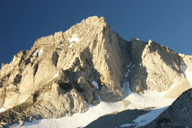 Bear Creek Spire viewed from the Dade Lake area.  The North Arete is the prominent Arete facing the viewer, with the NE Ridge being the line which crosses diagonally across the image starting in the bottom left corner.