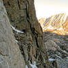 Adam waits at the bottom of the climb for Sun-Ribbon Arete.