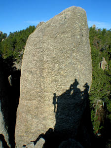 East face of Queen Pin. Silhouette of climbers finishing up Robbins route on Tricouni. May, 2003.
