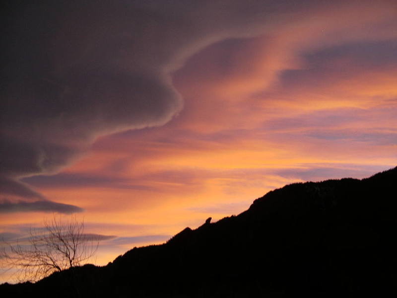 Clouds at sunset above the Flatirons.  Devil's Thumb visible in the skyline.