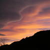 Clouds at sunset above the Flatirons.  Devil's Thumb visible in the skyline.