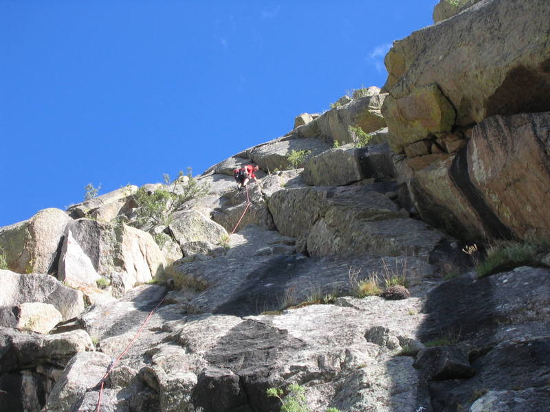 Nearing the P1 crux of Emerald City.  Due to the camera angle, the crux section appears to be just down and left of the climber.  The fixed piton is at the top of the diminishing, left-facing dihedral in shade, just left of the climber's left foot.