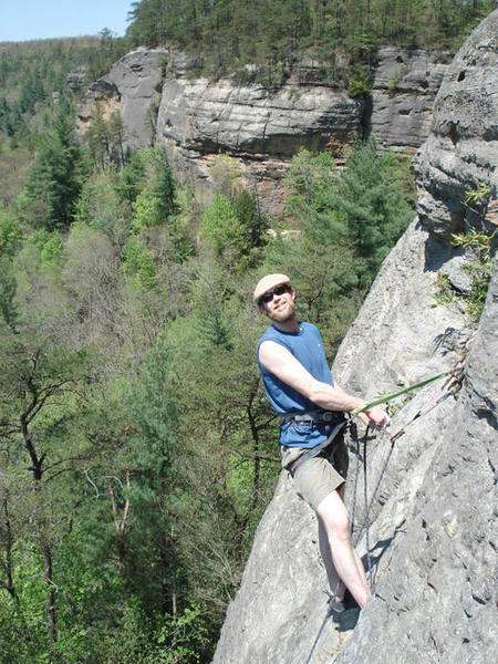 Casey atop one of the routes on the far right wall... roadside attraction is in the background...