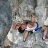 Tony Bubb heading up on the off-angled holds of 'Circumcision (6b)' at Nanyang Wall, in the Batu Caves area of K.L., Malaysia. Photo by Kenny Low, December 2006.