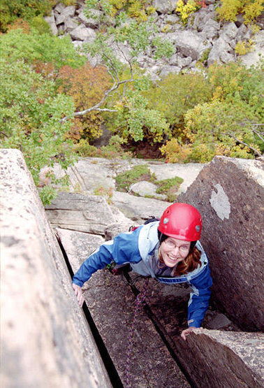 Heather nearing the top of the steep hand cracks on the 3rd pitch of Story of O.