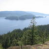 If you miss the turnoff on the trail and you continue up the main trail, this is where you end up. This picture is looking southeast over Indian Arm.  Belcarra is on the far shore and on the right horizon you see the buildings of Burnaby or Port Moody, just east of Simon Fraser University.