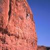 Tony Bubb leads 'Dirtbag' (10b) at Chuckawalla Wall, in St. George, UT. Joseffa Meir belays. Photo by unknown stranger.