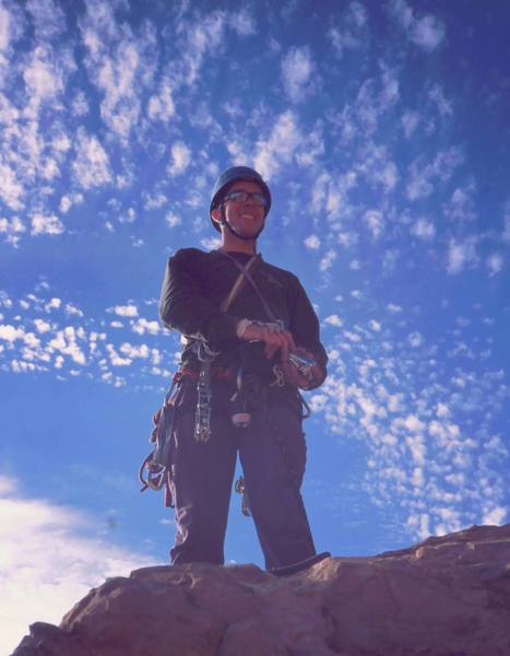 Chris Parks enjoys a dappled sky on the top of another Sedona Tower in 11/03. Photo by Tony Bubb.