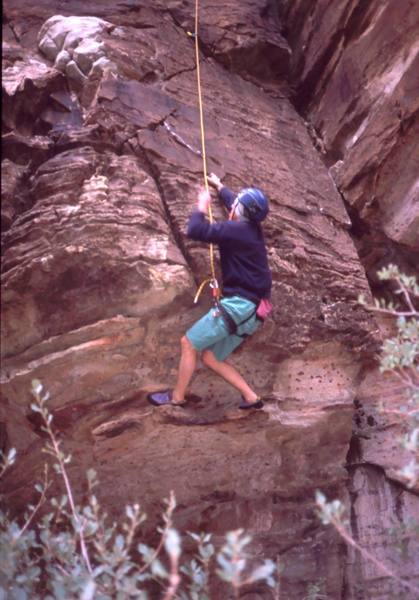 Alex Thayer deadpoints though the crux start to the first peice of gear on "Hot August Night" (5.11-) in Icebox Canyon. This route was done ground up trad. Photo by Tony Bubb, 4/06.