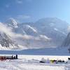 View of the SW side of the peak from the West Buttress/Cassin/West Rib Advanced Base Camp at 7,800 ft on the Kahiltna Glacier, at the mouth of the NE Fork of the Kahiltna Glacier (aka The Valley of Death - "VOD").  Prominent in the photo are the West Buttress(left skyline), the West Rim (Center, in the VOD) & the West Rib (sunlit ridge on the R in the VOD)  Note the numberous gaping crevasses in the mouth of the VOD.  You have to run this gauntlet in order to approach the West Rim, the West Rib and the Cassin Ridge via the VOD.