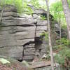 The second outcrop you encounter on the left, on your way up the Rose Ledge Foot Trail.