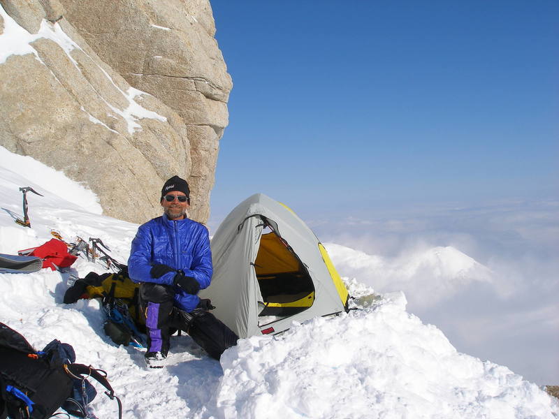 A tent platform shoveled out of a slope at 16,300 feet, just below the first rock band and a few feet above a series of poo-encrusted bivy platforms.  Throw your waste off the route, folks, or use the Clean Mountain Cans issued by the National Park Service, so others don't have to live with your piles.  Todd Kube photo.