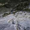 Above the lower ledge, looking down.  Dead center, their raised arms acknowledging the moment, are my two partners.  Tenaya. June 2007.