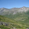 American Creek drainage with NE Fork crossing under Main Wall. Mount Prindle's summits with the primary climbing walls. View from shoulder (3000 ft elev.) of SE Fork of American Creek.