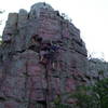 Rachel DeVries making a way through the crux of Two Kids and a Honda.  Joe Mokrycki is belaying from above.