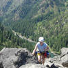 Topping out on Castle Rock after cleaning up the belay. The view is down canyon toward Leavenworth. July 4, 2007.