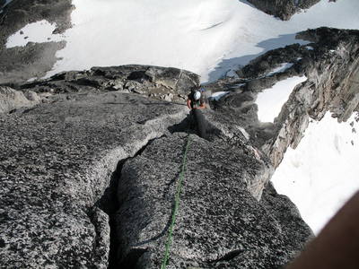 Taking the 5.9 hand crack variation off the belay ledge to the left of the low 5th class chimney system.  A good exit point, right, into the chimney system exists 50m.  A 5.10 corner crack continues above, however it is dirty and the gear/hand holds peter out near the top.  It is possible to traverse into the chimney system from the top of the 5.10 corner crack