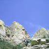 Scott Jones sweating out the descent hike after climbing the Middle Rabbit ear (directly behind him).