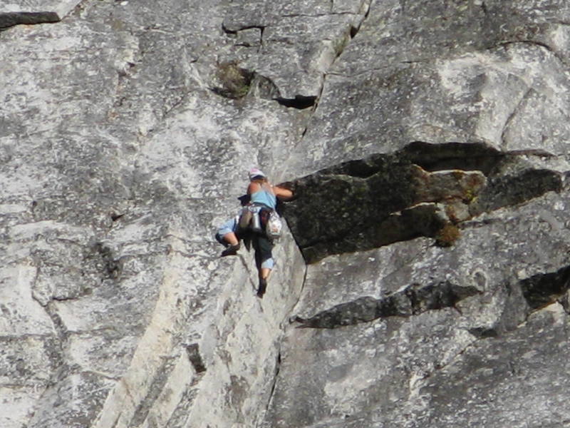 unknown climber making the crux move past the roof on pitch 2 of the haystack crack