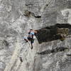 unknown climber making the crux move past the roof on pitch 2 of the haystack crack