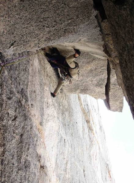 The business on pitch 4: transitioning from this position to an undercling is the crux move. The short undercling turns the roof just above Dave's right foot.  