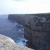 The Seaward (E) side of Point Perpendicular on Beecroft Peninsula, as seen from atop the Thunderbird Wall.  The lighthouse is sorta visible in the distance.