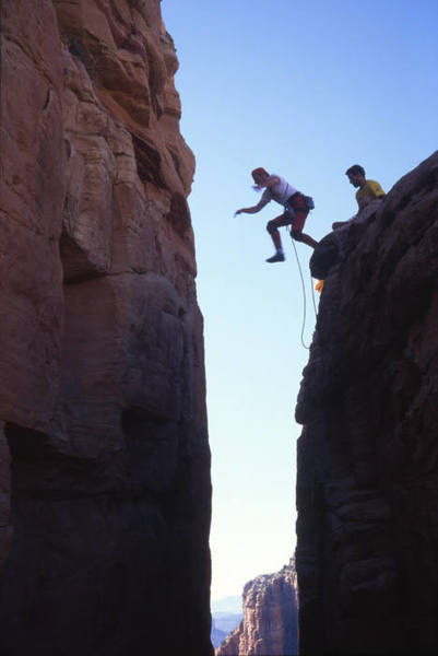 The famous jump-across move on Oak Creek Spire (L. Coats leading). Many a burly climber has been shut down by this purely psychological crux.