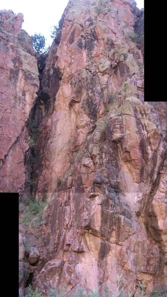 Composite pic of most of the Perp Area.  Routes are located on the small, triangular buttress in the lower half of the photo, and longer routes begin from the bushy area at the bottom of the slanting ledge above the small buttress.  Additional routes are to the right of the cliffs in this photo.