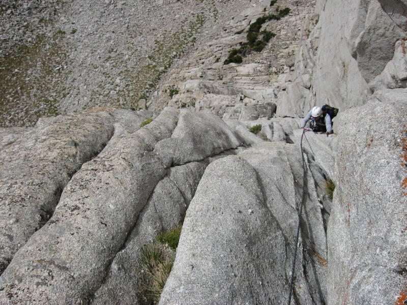 Looking down from the belay at the top of pitch three. Here you do an awkward exit from the bear hug cracks.