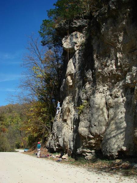 Hammond Cliff fall '06.  Climber on B. Unnamed 5.8+.  The yellow rope is hanging on G. Familiarus 10b.  It's hanging from the biners on the old anchor rope up top, please don't use this rope as an anchor-- if it's even still up there.  The slab closest to the photographer that's half in the shade is the start of K. Latrans 11b and L. Rufus 11d.  The top biners for Latrans are camoflauged, but you can catch the chains of Rufus at the top right of the photo.  Sweet '68 Rambler in the background.  Enjoy!