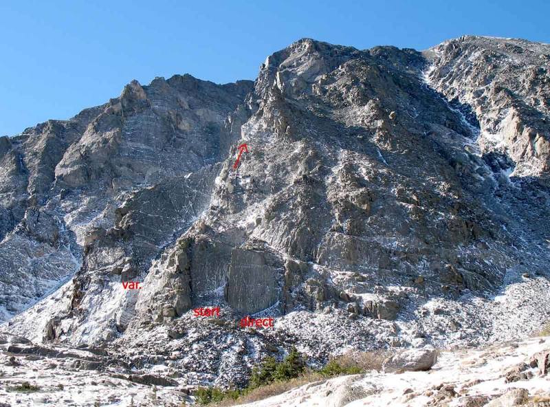 Directly below arete, just above lake. From other pictures, I think the standard start is up the middle slab. The stab to its right is harder and described as direct. There may be a variation up the gully and slab to the left.